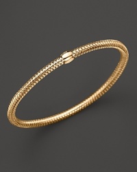 A modern mesh bangle in 18K yellow gold from Roberto Coin. A modern mesh bangle in 18K yellow gold from Roberto Coin.