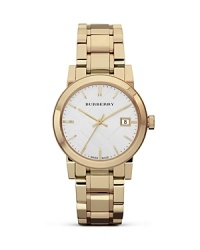 This simple, round watch from Burberry makes an unforgettable impression. Crafted of gold-plated stainless steel with a classic profile, it models sleek, timeless style. This simple, round watch from Burberry makes an unforgettable impression. Crafted of gold-plated stainless steel with a classic profile, it models sleek, timeless style.