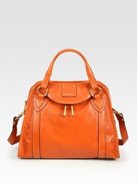 Buttery leather essential with striking goldtone hardware and dual straps, evokes unique downtown style.Double top handles, 4 drop Adjustable shoulder strap, 10-15 drop Top zip closure One outside zip pocket Protective metal feet One inside zip pocket One inside open pocket Fully lined 14W X 10H X 5D Made in Italy Buttery leather essential with striking goldtone hardware and dual straps, evokes unique downtown style.Double top handles, 4 drop Adjustable shoulder strap, 10-15 drop Top zip closure One outside zip pocket Protective metal feet One inside zip pocket One inside open pocket Fully lined 14W X 10H X 5D Made in Italy