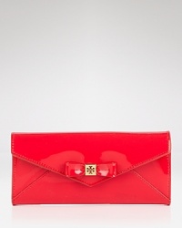 This Tory Burch leather wallet is dressed up in a charming bow. This continental design unsnaps to reveal a well-organized interior with a zip pocket and four card slots. This Tory Burch leather wallet is dressed up in a charming bow. This continental design unsnaps to reveal a well-organized interior with a zip pocket and four card slots.