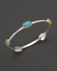 Turquoise stations in 24K yellow gold bring vibrant style to this hammered sterling silver bangle from Gurhan. Turquoise stations in 24K yellow gold bring vibrant style to this hammered sterling silver bangle from Gurhan.