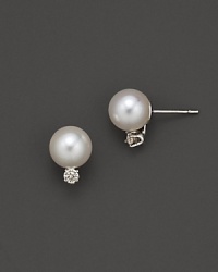 Diamonds add sparkle to shimmering pearl studs set in white gold. Diamonds add sparkle to shimmering pearl studs set in white gold.