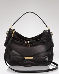 In luxe bridle leather, Burberry's Dutton hobo takes center stage with buckle belting details and gleaming gold-tone hardware. In luxe bridle leather, Burberry's Dutton hobo takes center stage with buckle belting details and gleaming gold-tone hardware.