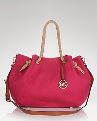 MICHAEL Michael Kors gives this classic, cotton tote a freshly luxurious feel with leather trims. It's a little preppy, and wholly practical. MICHAEL Michael Kors gives this classic, cotton tote a freshly luxurious feel with leather trims. It's a little preppy, and wholly practical.
