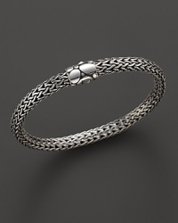 Small sterling woven chain bracelet with Kali motif clasp, designed by John Hardy. Small sterling woven chain bracelet with Kali motif clasp, designed by John Hardy.