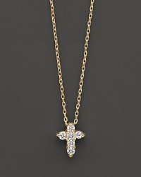 A diamond cross necklace in yellow gold. With signature ruby accent. Designed by Roberto Coin. A diamond cross necklace in yellow gold. With signature ruby accent. Designed by Roberto Coin.