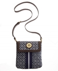 Keep it classic with this tasteful crossbody from Tommy Hilfiger. A timeless signature exterior features a preppy stripe at center and iconic goldtone hardware at front. Keep it classic with this tasteful crossbody from Tommy Hilfiger. A timeless signature exterior features a preppy stripe at center and iconic goldtone hardware at front.