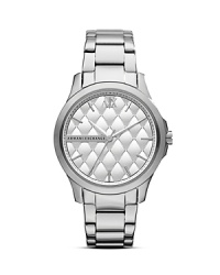 A quilted matte dial tops this sleek and round Armani Exchange watch, adding textured interest to a timeless plated stainless steel bracelet. A quilted matte dial tops this sleek and round Armani Exchange watch, adding textured interest to a timeless plated stainless steel bracelet.