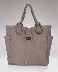 Casual, crinkled and cool, this tote features knotted straps,a sleek shape, and plenty of room for everything from magazines to makeup bags. Casual, crinkled and cool, this tote features knotted straps,a sleek shape, and plenty of room for everything from magazines to makeup bags.