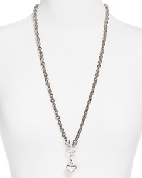 Charmed we're sure. Juicy Couture hits the links with this bold pendant necklace, crafted of plated metal and accented by a delicate heart-shaped pendant. Charmed we're sure. Juicy Couture hits the links with this bold pendant necklace, crafted of plated metal and accented by a delicate heart-shaped pendant.