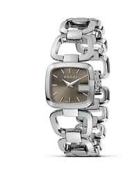 First introduced in the late ‘60s, the famous Gucci G quickly became a worldwide sensation. It has been elegantly revisited in this stainless steel timepiece.The bezel takes the form of a G in a subtle yet distinctive way, perfectly matching the design of the smooth bracelet and enhancing the model's personality. The watch face is completed by a brown sun-brushed dial. First introduced in the late ‘60s, the famous Gucci G quickly became a worldwide sensation. It has been elegantly revisited in this stainless steel timepiece.The bezel takes the form of a G in a subtle yet distinctive way, perfectly matching the design of the smooth bracelet and enhancing the model's personality. The watch face is completed by a brown sun-brushed dial.