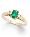 Enviable green hues. This vibrant 14k gold ring features an oval-cut emerald (3/8 ct. t.w.) and round-cut diamond side stones (1/8 ct. t.w.).