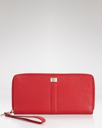 Pack up the out-of-town essentials with this bold leather travel clutch from Cole Haan, featuring fifteen card slots, multiple bill fold, and a secure coin compartment. Pack up the out-of-town essentials with this bold leather travel clutch from Cole Haan, featuring fifteen card slots, multiple bill fold, and a secure coin compartment.