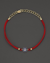 Diamonds and blue sapphires in 14K. yellow gold from a dazzling evil eye charm, strung on red rope. By Meira T. Diamonds and blue sapphires in 14K. yellow gold from a dazzling evil eye charm, strung on red rope. By Meira T.