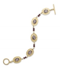 Alluring amethyst hues create a timeless feel to this bracelet from Lauren Ralph Lauren. Textured oval pendants highlight glass cabochons. Ring and toggle closure. Crafted in 14k worn gold-plated brass. Approximate length: 7-1/2 inches. Alluring amethyst hues create a timeless feel to this bracelet from Lauren Ralph Lauren. Textured oval pendants highlight glass cabochons. Ring and toggle closure. Crafted in 14k worn gold-plated brass. Approximate length: 7-1/2 inches.