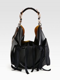 A modern, leather style with feminine ribbons and a detachable zipper pouch for easy access to your smaller essentials.Top handle, 8 dropAdjustable shoulder strap, 15½ to 20 dropRibbon tie closureThree tie close outside pocketsDetachable zipper pouchContrast inside15½W X 13¾H X ¾DMade in Italy A modern, leather style with feminine ribbons and a detachable zipper pouch for easy access to your smaller essentials.Top handle, 8 dropAdjustable shoulder strap, 15½ to 20 dropRibbon tie closureThree tie close outside pocketsDetachable zipper pouchContrast inside15½W X 13¾H X ¾DMade in Italy