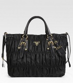 Gaufre nylon carryall paired with rich leather trim and polished hardware.Double top handles, 4½ dropRemovable adjustable shoulder strap, 19-21 dropTop snap closureMetal lettering logoGold-plated hardwareOne inside zip pocketTwo cellphone/credit card pocketsPrada logo lining14W X 11H X 6DMade in Italy