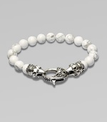 A new look for the modern man, handsomely crafted with a sterling silver raven's head clasp and a string of howlite beads.Sterling silverLobster claspBracelet, 9 longAbout 3 diamImported