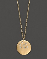 A scattering of diamonds lights up a 14K gold medallion pendant. A scattering of diamonds lights up a 14K gold medallion pendant.