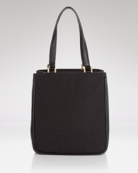 The perfectly proportioned tote in stitched leather. Effortless accessorizing takes a trip uptown with this bag from Tory Burch, accented by a bold buckle closure. The perfectly proportioned tote in stitched leather. Effortless accessorizing takes a trip uptown with this bag from Tory Burch, accented by a bold buckle closure.