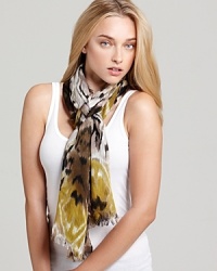 A bohemian oblong scarf with colorful ikat print and self fringe edges. A bohemian oblong scarf with colorful ikat print and self fringe edges.
