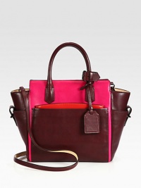 An elegant zip-top tote designed to balance function and luxury with a soft geometry.Double top handles, 4½ dropDetachable adjustable shoulder strap, 21½-23 dropTop zip closureThree outside open pocketsOne detachable zip pouchOne inside zip pocketTwo inside open pockets9½W X 10H X 5DImported An elegant zip-top tote designed to balance function and luxury with a soft geometry.Double top handles, 4½ dropDetachable adjustable shoulder strap, 21½-23 dropTop zip closureThree outside open pocketsOne detachable zip pouchOne inside zip pocketTwo inside open pockets9½W X 10H X 5DImported