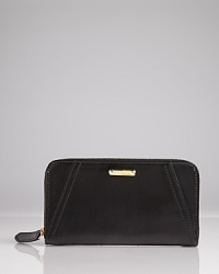 Effortlessly blending style and functionality, this Burberry wallet is a polished pick up, crafted of leather with a zip around closure which opens to multiple pockets. Effortlessly blending style and functionality, this Burberry wallet is a polished pick up, crafted of leather with a zip around closure which opens to multiple pockets.