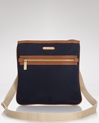 Champion practical (and portable) style with this slim nylon crossbody from MICHAEL Michael Kors, sure to add on-the-go ease to every look. Champion practical (and portable) style with this slim nylon crossbody from MICHAEL Michael Kors, sure to add on-the-go ease to every look.