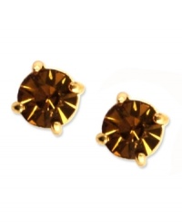 Go for sultry color with Anne Klein's stud earrings. Round-cut cubic zirconia in topaz hues complement your seasonal looks. Set in gold tone mixed metal. Approximate diameter: 1/3 inch. Go for sultry color with Anne Klein's stud earrings. Round-cut cubic zirconia in topaz hues complement your seasonal looks. Set in gold tone mixed metal. Approximate diameter: 1/3 inch.
