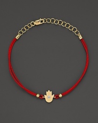 Diamonds in 14K. yellow gold from a dazzling hamsa charm, strung on red rope. By Meira T. Diamonds in 14K. yellow gold from a dazzling hamsa charm, strung on red rope. By Meira T.