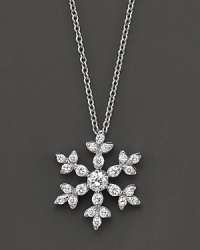 A diamond snowflake pendant has a round center stone. Set in 14 Kt. white gold. A diamond snowflake pendant has a round center stone. Set in 14 Kt. white gold.