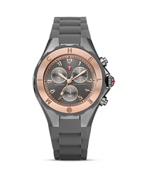 Make time for arm candy with Michele's sweet and sporty Jelly Bean watch, styled with an engraved bezel, three-eye chronograph dial, and silicone strap. Make time for arm candy with Michele's sweet and sporty Jelly Bean watch, styled with an engraved bezel, three-eye chronograph dial, and silicone strap.