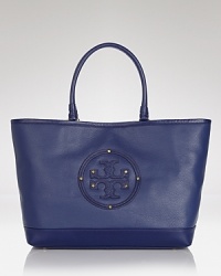 Clean lines and a strong shape makes Tory Burch's tote both classic and modern. Crafted from luxurious leather with a spacious design, it's a practically perfect for running errands. Clean lines and a strong shape makes Tory Burch's tote both classic and modern. Crafted from luxurious leather with a spacious design, it's a practically perfect for running errands.