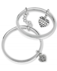 Retro fashion from GUESS. These bangle bracelets are linked together with a chain adding stackable style. Featuring dangling heart charms with black epoxy and crystal accents. Crafted in silver tone mixed metal. Approximate diameter: 2-1/2 inches. Approximate drop: 1 inch. Retro fashion from GUESS. These bangle bracelets are linked together with a chain adding stackable style. Featuring dangling heart charms with black epoxy and crystal accents. Crafted in silver tone mixed metal. Approximate diameter: 2-1/2 inches. Approximate drop: 1 inch.