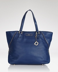 A simple, spacious daybag with a versatile twist. This leather-crafted DNKY tote is subtly structured and secured with a zipper which opens to a lined interior with multiple pockets. A simple, spacious daybag with a versatile twist. This leather-crafted DNKY tote is subtly structured and secured with a zipper which opens to a lined interior with multiple pockets.