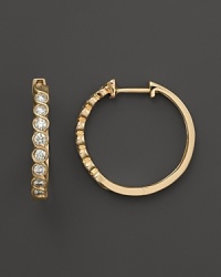 Diamonds set in 14K. yellow gold hoops. Diamonds set in 14K. yellow gold hoops.