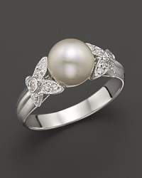 Brilliant diamonds, set in 14K. white gold butterfly accents, frame a gleaming cultured pearl. Brilliant diamonds, set in 14K. white gold butterfly accents, frame a gleaming cultured pearl.