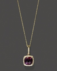 Diamonds frame a faceted amethyst, set in 14K yellow gold. Diamonds frame a faceted amethyst, set in 14K yellow gold.
