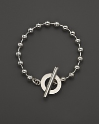 A bold toggle closure finishes this sterling silver circle bracelet. A bold toggle closure finishes this sterling silver circle bracelet.