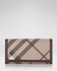 Burberry's iconic check print in muted neutrals lends sophisticated style to this leather trimmed continental wallet. Burberry's iconic check print in muted neutrals lends sophisticated style to this leather trimmed continental wallet.