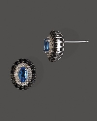 Diamonds and black diamonds circle faceted London blue topaz, set in 14K white gold. Diamonds and black diamonds circle faceted London blue topaz, set in 14K white gold.