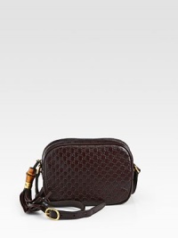 It's all in the name. This feminine cross body bag goes from Monday to Friday then straight through the weekend.Soft microguccissima leatherLeatherAntique gold hardwareLeather tassel with bamboo detail zipper-pullAdjustable shoulder strap and hand-painted edges, 19.7 dropTop zip closureInterior open and cell pocketsNatural cotton linen liningSmall size: 7.5W x 5.5H x 2.8DMade in Italy It's all in the name. This feminine cross body bag goes from Monday to Friday then straight through the weekend.Soft microguccissima leatherLeatherAntique gold hardwareLeather tassel with bamboo detail zipper-pullAdjustable shoulder strap and hand-painted edges, 19.7 dropTop zip closureInterior open and cell pocketsNatural cotton linen liningSmall size: 7.5W x 5.5H x 2.8DMade in Italy