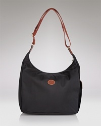 Longchamp's nylon hobo is a fuss-free take on a classic shape. Carry the pretty-practical style to add an enviable dose of Parisian chic to everyday looks. Longchamp's nylon hobo is a fuss-free take on a classic shape. Carry the pretty-practical style to add an enviable dose of Parisian chic to everyday looks.