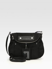 Lightweight nylon with leather accents in a soft frame with a zippered flap closure.Adjustable leather shoulder strap, 18-21 dropMagnetic snap flap closureOne zip pocket on flapOne outside open pocketRemovable leather luggage tagOne inside zip pocketTwo inside open pocketsSignature lining11½W X 11H X 3¼DImported Lightweight nylon with leather accents in a soft frame with a zippered flap closure.Adjustable leather shoulder strap, 18-21 dropMagnetic snap flap closureOne zip pocket on flapOne outside open pocketRemovable leather luggage tagOne inside zip pocketTwo inside open pocketsSignature lining11½W X 11H X 3¼DImported