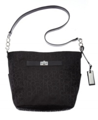 A luxuriously functional look you'll use every single day. This signature jacquard messenger bag from Calvin Klein features a perfectly totable messenger silhouette and shiny silvertone hardware for a touch od posh. A luxuriously functional look you'll use every single day. This signature jacquard messenger bag from Calvin Klein features a perfectly totable messenger silhouette and shiny silvertone hardware for a touch od posh.