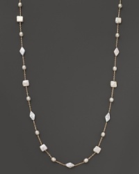 Freshwater pearls dot a dainty 14K. yellow gold chain. Freshwater pearls dot a dainty 14K. yellow gold chain.