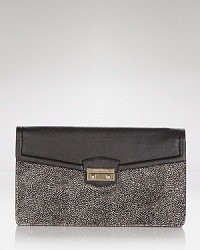The effortless style of this Cole Haan clutch is ready for night, crafted of leather and designed with pockets to hold all of the desk-to-dinner essentials. The effortless style of this Cole Haan clutch is ready for night, crafted of leather and designed with pockets to hold all of the desk-to-dinner essentials.