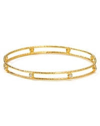 Delicately crafted from 18-karat gold plate and set with understated, clear-crystal stones, Melinda Maria's hammered bangle lends an elegant touch of sparkle. Delicately crafted from 18-karat gold plate and set with understated, clear-crystal stones, Melinda Maria's hammered bangle lends an elegant touch of sparkle.
