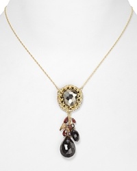 A bold, bejeweled cluster of stones, crystals, and pearls adorns this Alexis Bittar necklace, cast in gold plated metal. A bold, bejeweled cluster of stones, crystals, and pearls adorns this Alexis Bittar necklace, cast in gold plated metal.