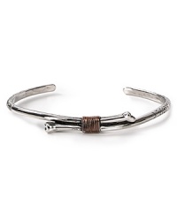 Add a touch of downtown cool to your jewelry collection with this engraved silver-plated bone cuff with rose gold wire wrapping. Add a touch of downtown cool to your jewelry collection with this engraved silver-plated bone cuff with rose gold wire wrapping.
